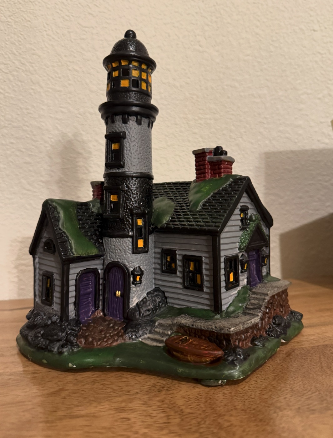 A hand-painted ceramic lighthouse house, one of Renee's craft projects